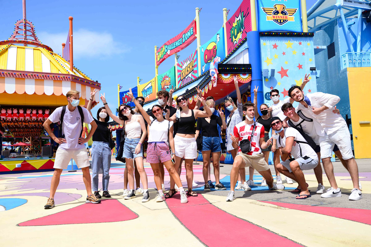 HKBU students smile and pose with peace signs at a carnival