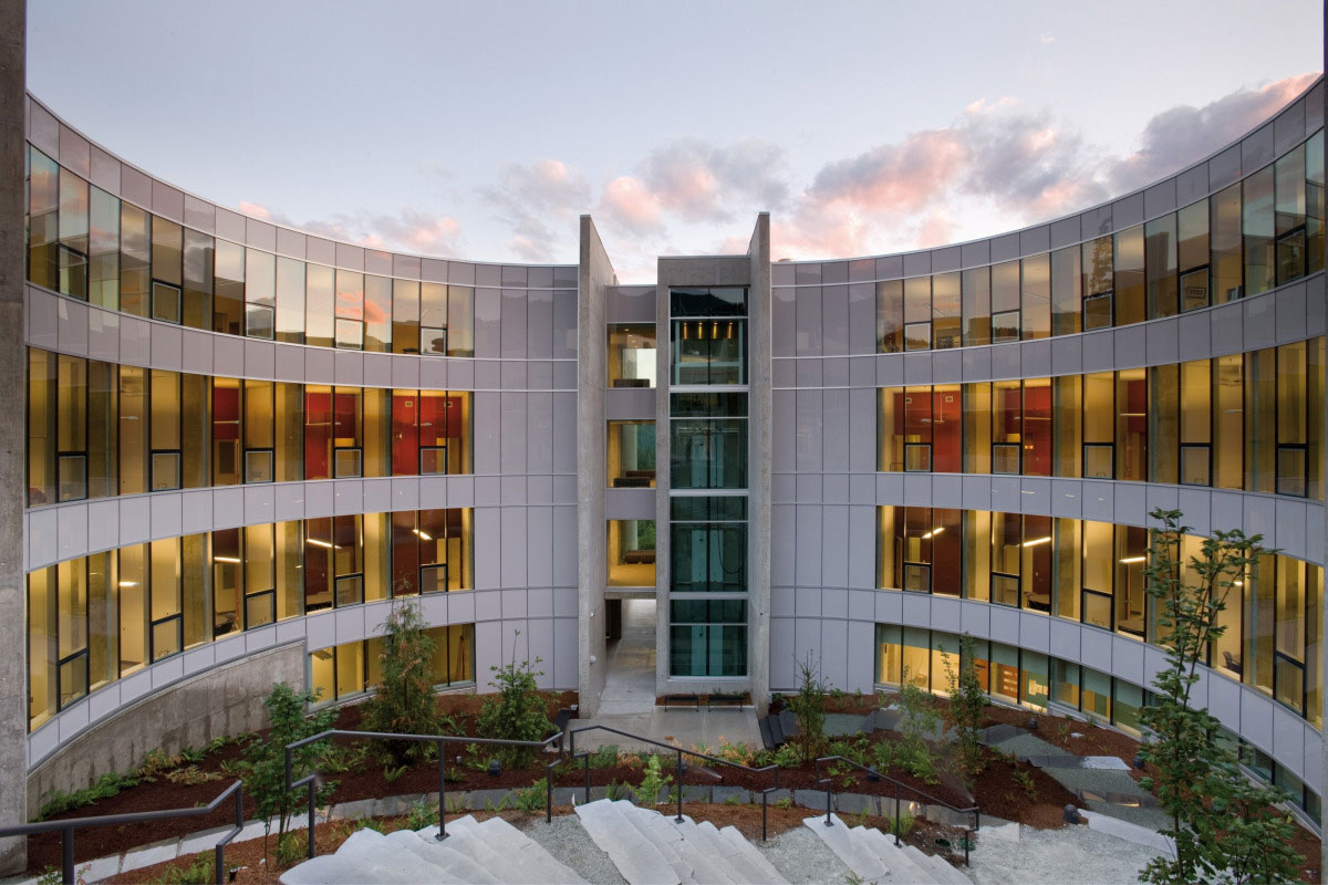Exterior shot of Quest University Canada's rounded, glass paneled building